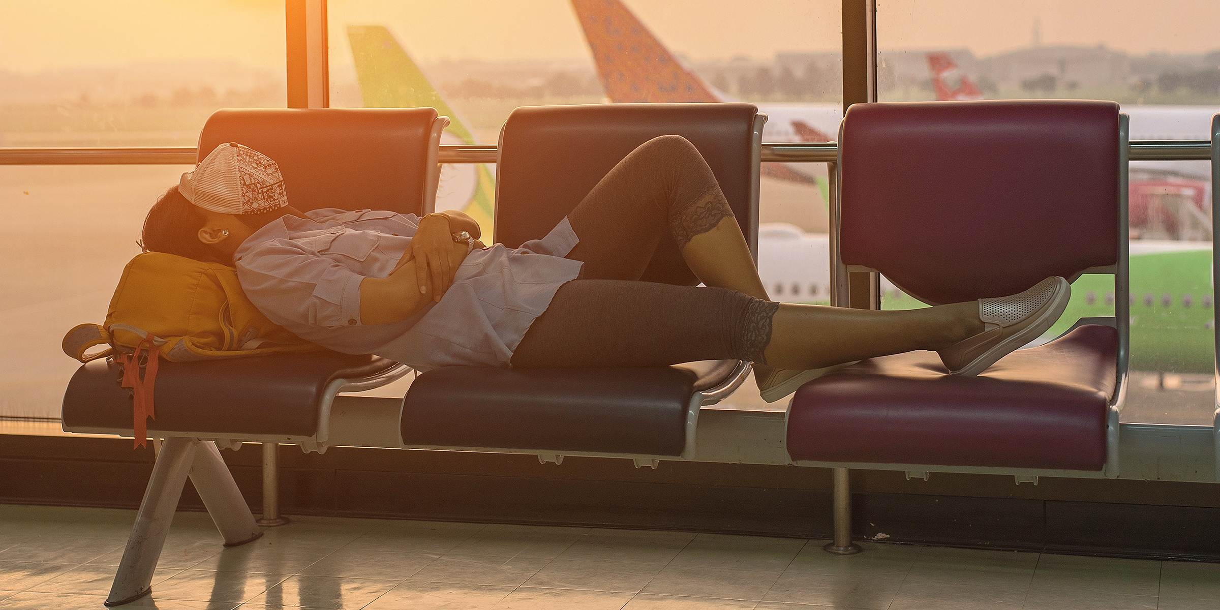 A person sleeping in an airport | Source: Shutterstock