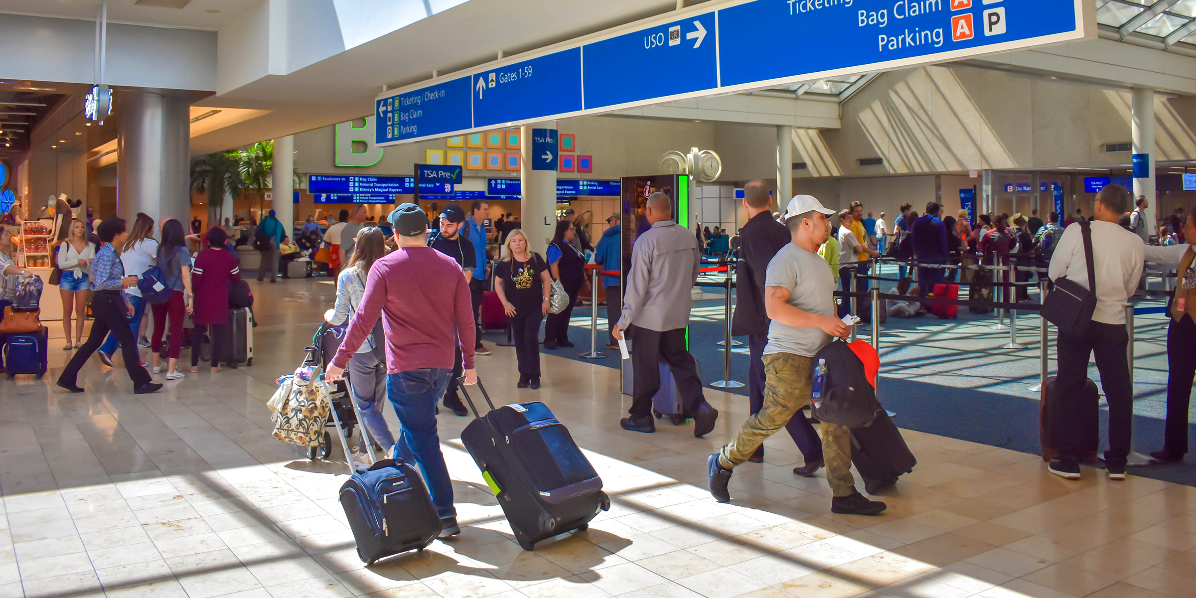 Travelers strolling through the airport | Source: Shutterstock
