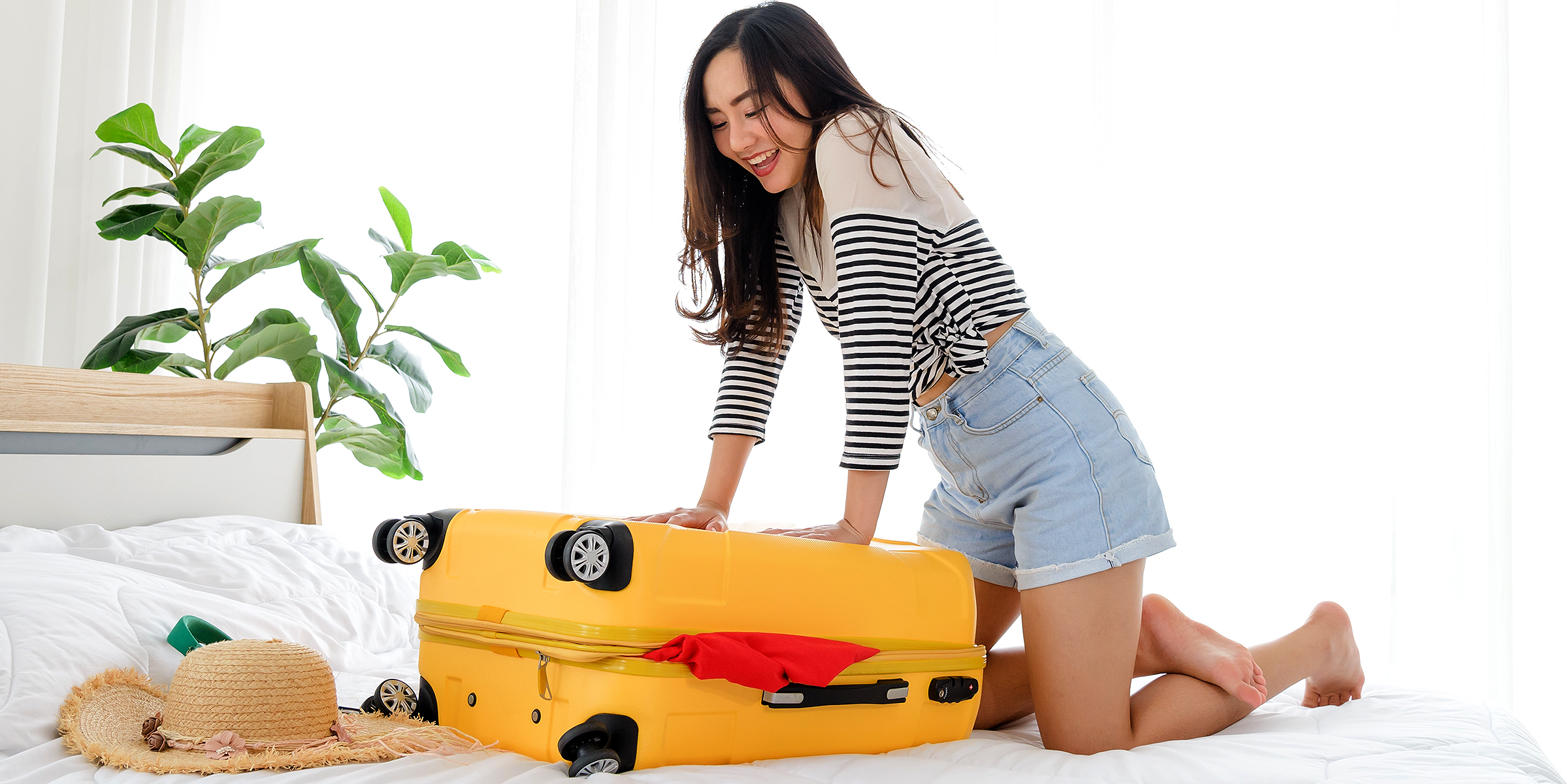 A woman packs her suitcase | Source: Shutterstock