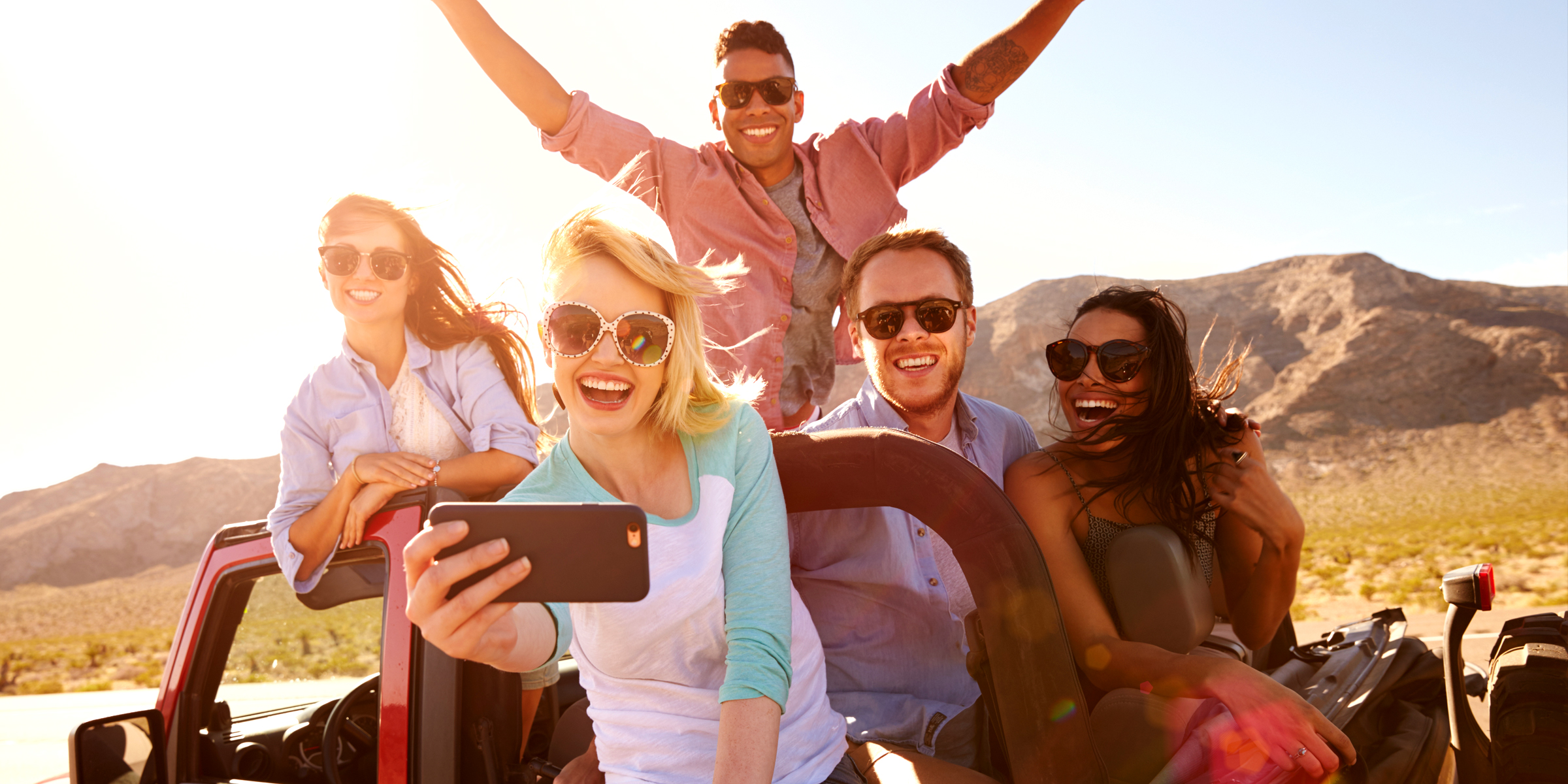 A group of friends taking a selfie while on a road trip | Source: Shutterstock